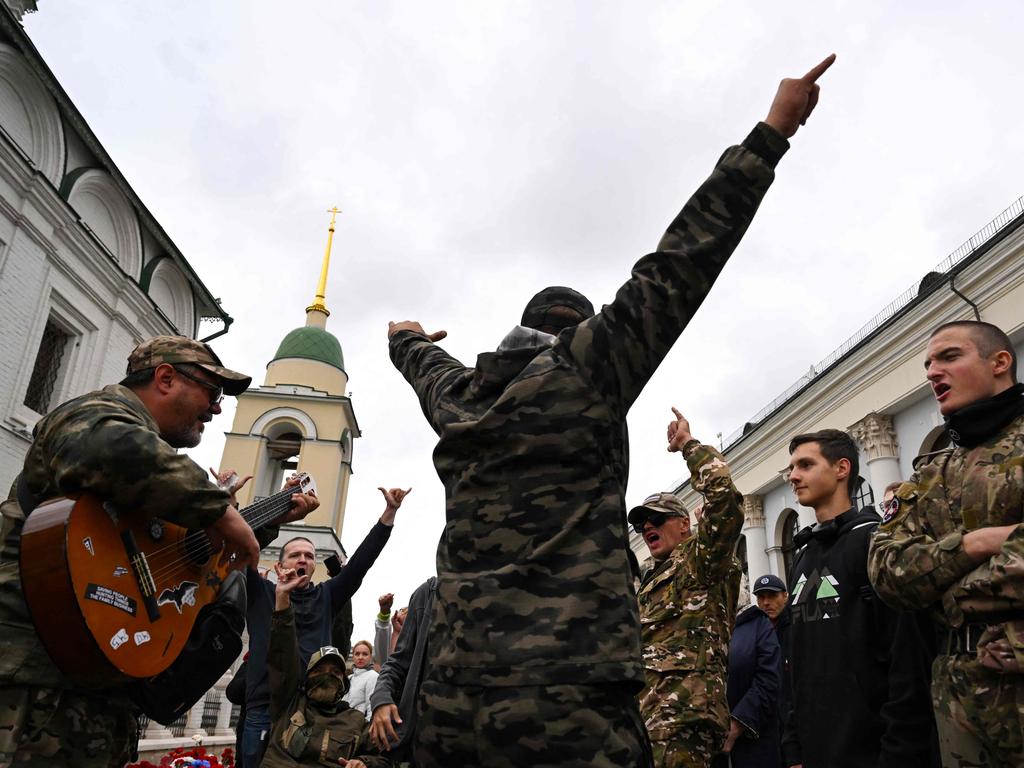 People, including those wearing camouflage uniforms, visit a makeshift memorial for Wagner private mercenary group chief Yevgeny Prigozhin in central Moscow on October 1, 2023, to mark 40 days since his death as per Orthodox tradition.