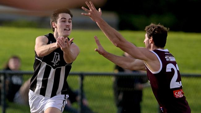 Darley’s Zane Le Huray gets a handball past Ryan Carter of Melton. Picture: Andy Brownbill