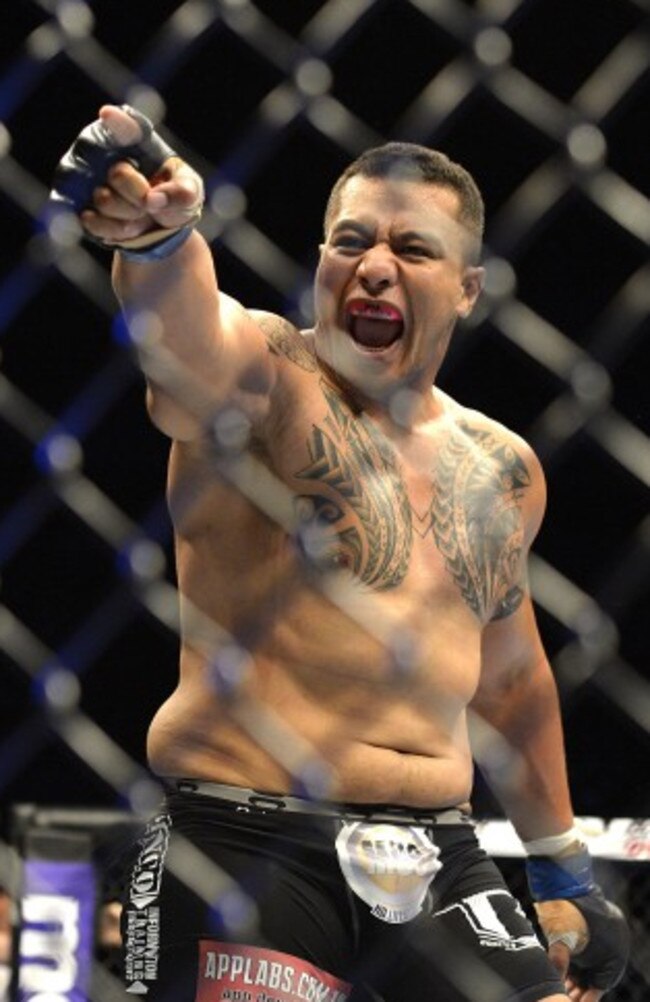 Aussie Soa Palelei looks to the crowd after putting away Pat Barry at the Brisbane Entertainment Centre.