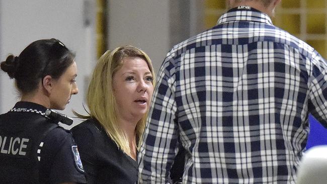 Laura Black seen being led away by police at Townsville University Hospital. It comes after a woman arrived at the Townsville University Hospital with a dead child in her car.