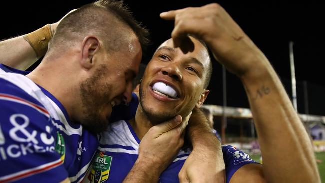 Josh Reynolds of the Bulldogs embraces teammate Moses Mbye of the Bulldogs after scoring the winning try.