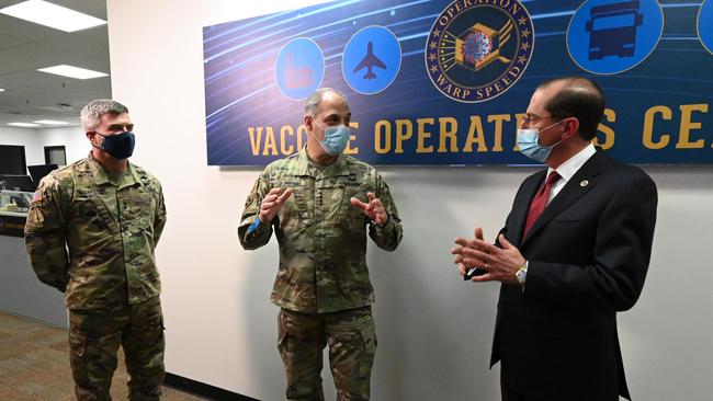 US Health and Human Services Secretary Alex Azar (R) and General Gus Perna (C) visiting the Operation Warp Speed Vaccine Operation Center (VOC) in Washignton, DC on Saturday. Picture: AFP