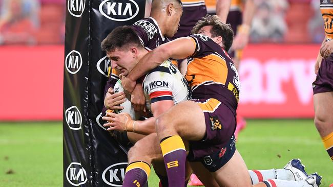 Two Broncos can’t stop Victor Radley. Photo: Bradley Kanaris/Getty Images