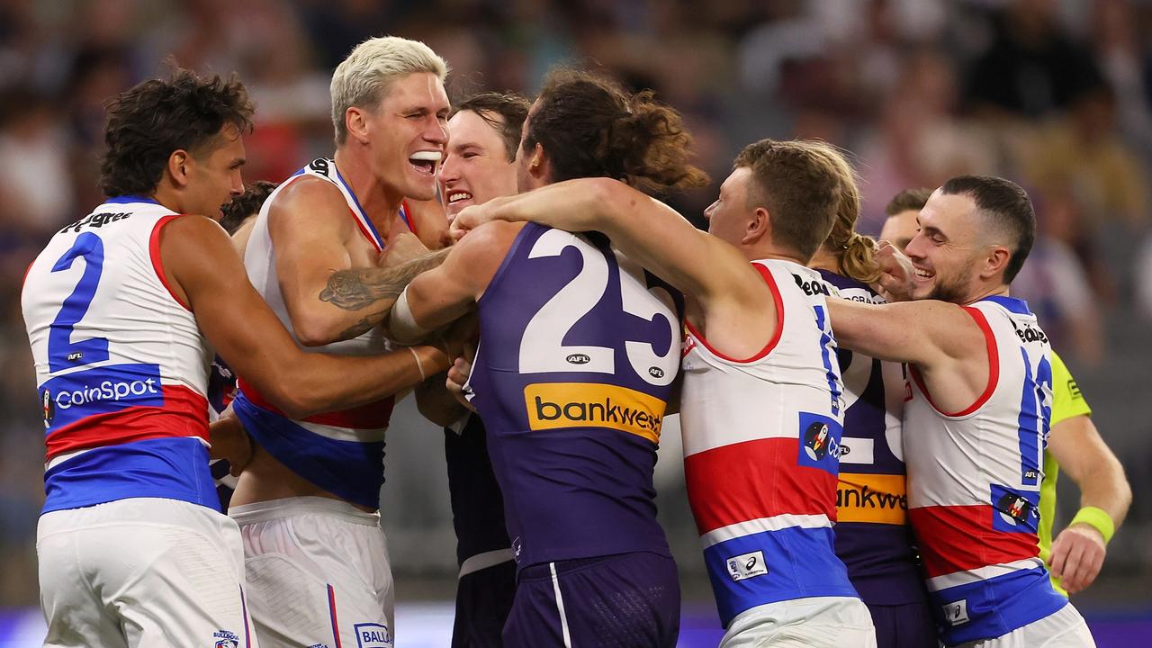 PERTH, AUSTRALIA – APRIL 21: Alex Pearce of the Dockers and Rory Lobb of the Bulldogs wrestle before the first bounce during the round six AFL match between Fremantle Dockers and Western Bulldogs at Optus Stadium, on April 21, 2023, in Perth, Australia. (Photo by Paul Kane/Getty Images)