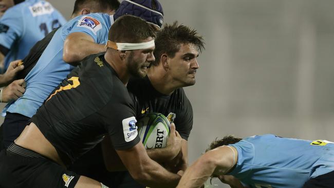 Pablo Matera protects the ball from Waratahs flanker Michael Hooper.