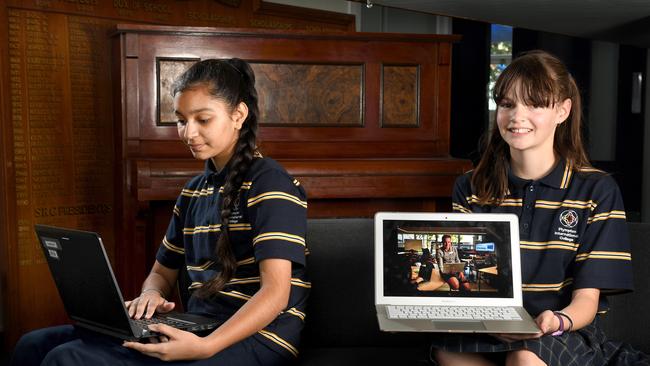 Plympton International High students Anu Kaur, 13, and Hayley Rathjen, 12, learning school lessons online. Picture: Tricia Watkinson