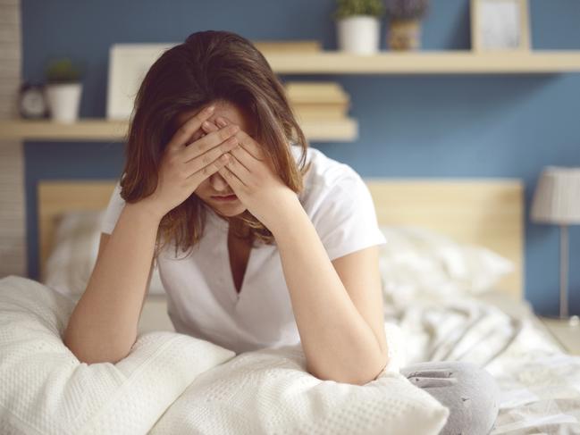 Unhappy girl in a bedroom - Stock image ipad generic