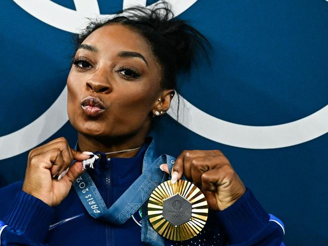 The GOAT Simone Biles poses with her gold medal and a goat necklace because as she should. Picture: Loic VENANCE / AFP