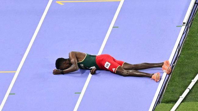 Ethiopia's Lamecha Girma lies on the track during the men's 3000m steeplechase final of the athletics event at the Paris 2024 Olympic Games at Stade de France in Saint-Denis, north of Paris, on August 7, 2024. Picture: Ben Stansall/AFP