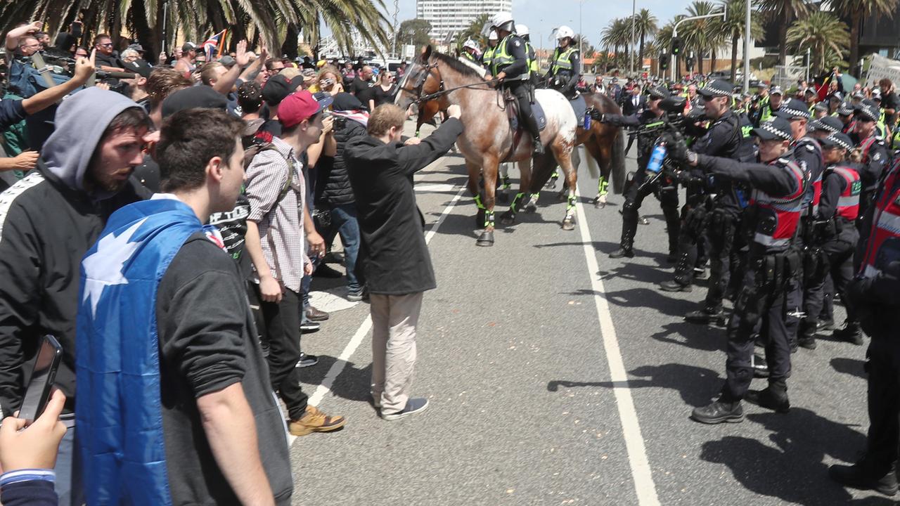 Police had to keep protesters apart on the St Kilda foreshore in Melbourne on Saturday. Picture: AAP