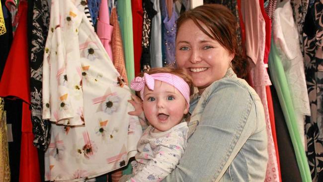 DESIGNER DASH: Kelly Atkinson and seven-month old Macy have fun playing with the beautiful dresses in Warwick's newest designer boutique, Never Wear It Twice. Picture: Marian Faa