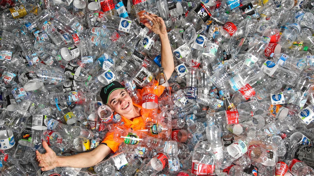 Counter and sorter for Containers for Change depot in Coorparoo, Sabastian Bailey, in a sea of recycled plastic bottles. Picture: Zak Simmonds