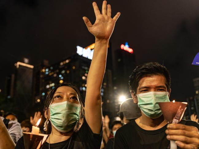 HONG KONG, CHINA - JUNE 4: Participants hold candles as they take part in a memorial vigil in Victoria Park on June 4, 2020 in Hong Kong, China. Thousands gathered for the annual memorial vigil in Victoria Park to mark the 1989 Tiananmen Square Massacre despite a police ban citing coronavirus social distancing restrictions. (Photo by Anthony Kwan/Getty Images)