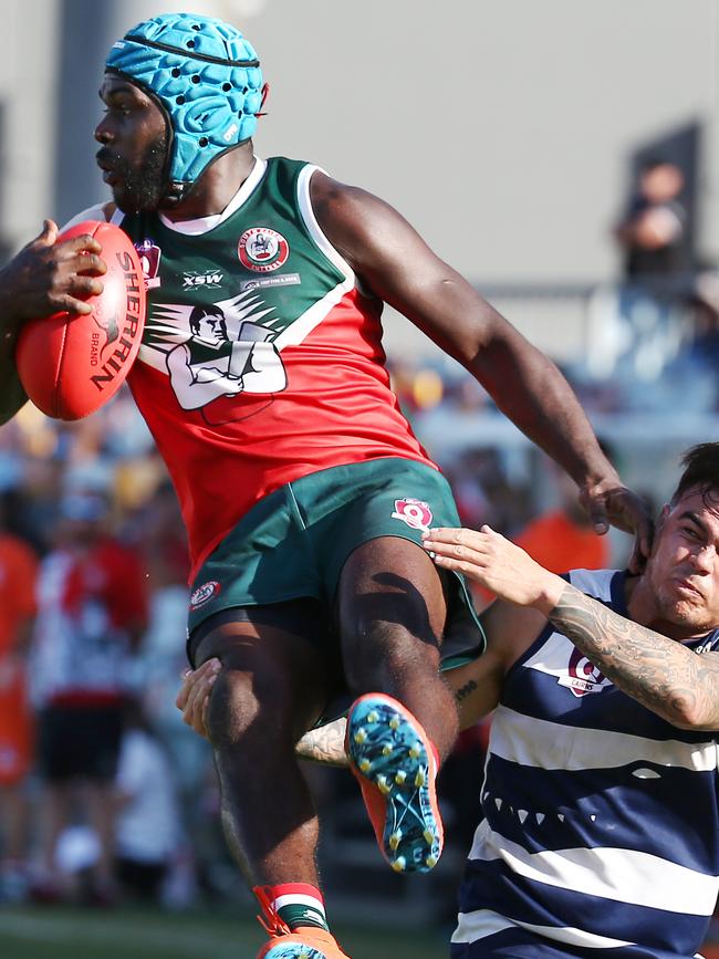 South Cairns' Dwayne Bosen is tackled mid air by Port Douglas' Kurt Bradshaw in the AFL Cairns men's grand final match between the Port Douglas Crocs and the South Cairns Cutters, played at Cazalys Stadium. PICTURE: BRENDAN RADKE.