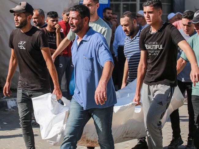 Palestinian mourners carry the body of a victim of Israeli bombardment, outside a hospital in Deir el-Balah. Picture: AFP