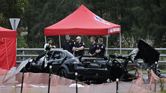 Police look over the crime scene of the fatal car crash which happened early on Sunday. Picture: Adam Yip/Second Story