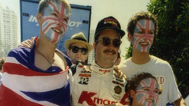 British racing driver Nigel Mansell after his win at the Gold Coast Indy with three British fans, Jim Harriman, 22, of Nottingham, Jim Baker, 18, of Glasgow, and Richard Badger, 21, of Rotheram.