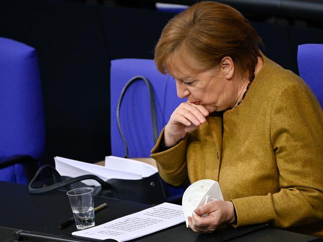 German Chancellor Angela Merkel goes through her documents before addressing the Bundestag on the government's measures to fight the coronavirus pandemic. Picture: AFP