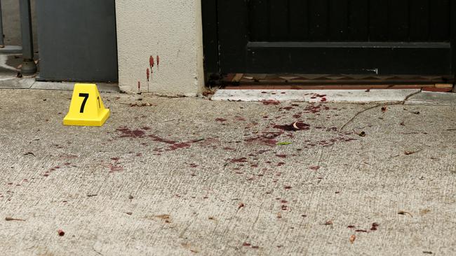 Blood was splattered on the footpath near the home in Ferris Street, Annandale. Picture: Richard Dobson