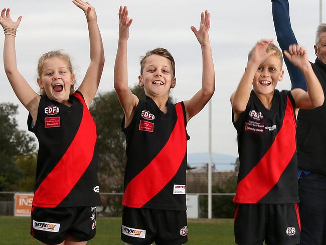 Pascoe Vale Football Club is celebrating its 100th year witha gala later this month. Emilee 7, Jacob,9, Lochie 12 Ashworth with some of the past and present people involved with the club.10th July, Pascoe Vale, MelbournePicture : George Salpigtidis