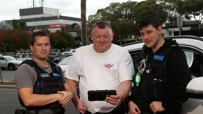 Senior Constable Nathan Browne, Sergeant Stuart White and Constable Dan Walo scan car details in Broadmeadows. Picture: Hamish Blair