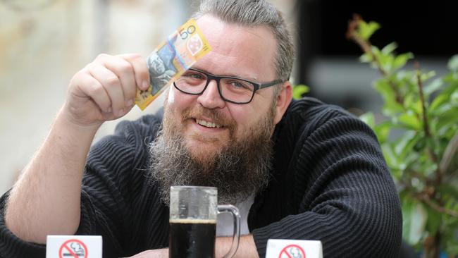 Reformed smoker Hayden Naughton with some of the cash he’s saved since giving up smoking. Picture: AAP Image/Dean Martin