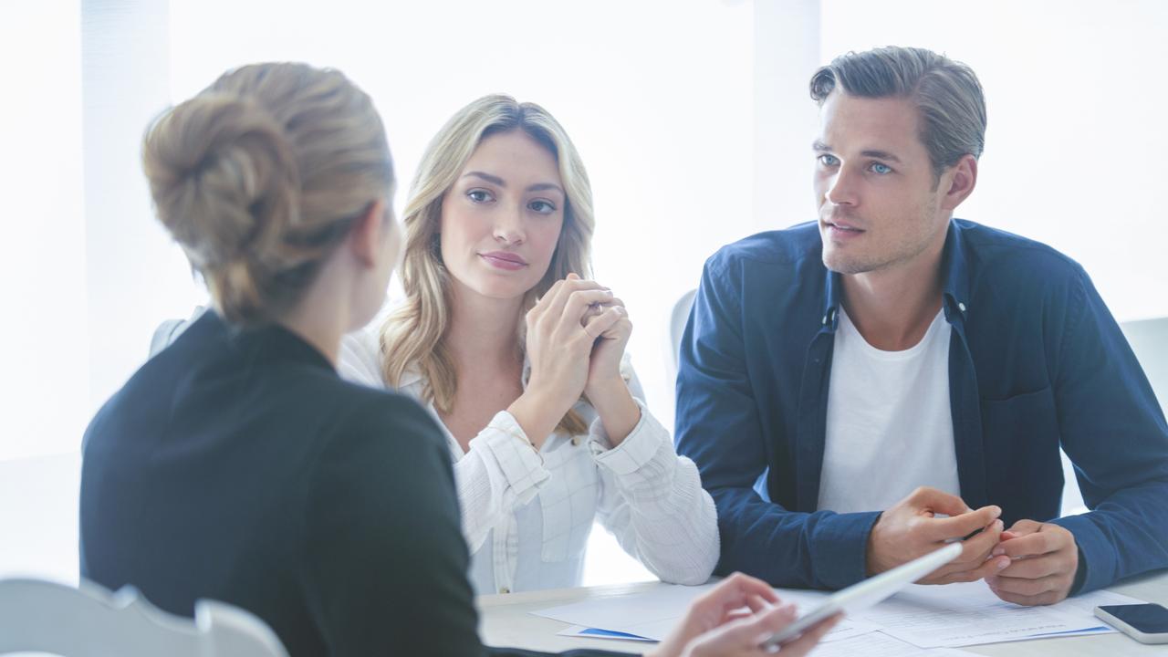 A couple discussing their home loan with a mortgage broker. Picture: iStock.