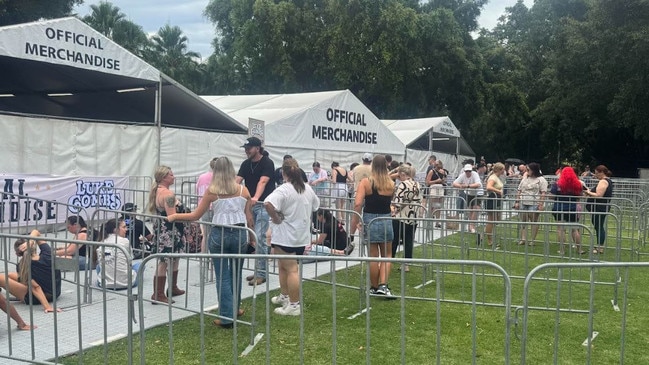 People lining up at the closed merchandise tents ahead of the first Luke Combs concert at Suncorp Stadium.