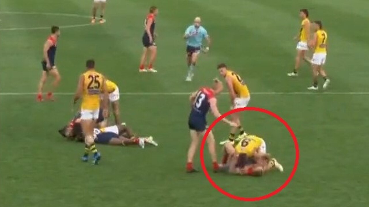 Trent Cotchin tangles with James Harmes at Casey Fields.