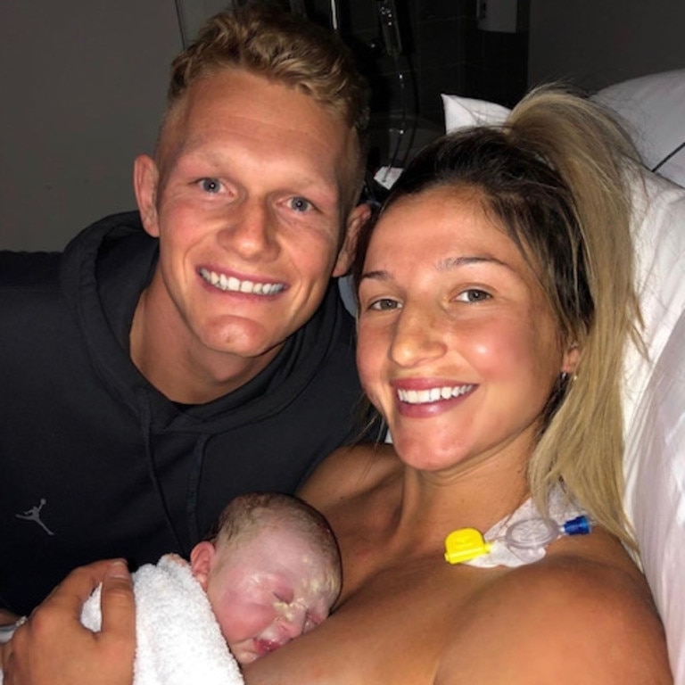 Adam Treloar and Kim Ravaillion with their baby.