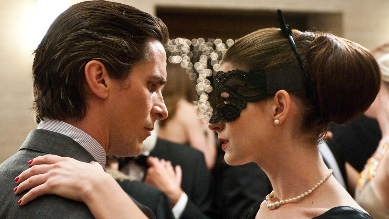 Christian Bale as Bruce Wayne and Anne Hathaway as Catwoman in The Dark Knight Rises.