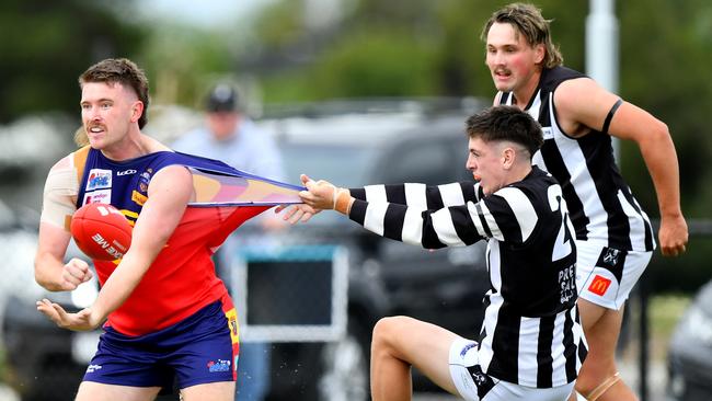 Mitchell Day of Diggers Rest is tackled by Owen Fowler of Wallan during Saturday’s RDFNL match. (Photo by Josh Chadwick)