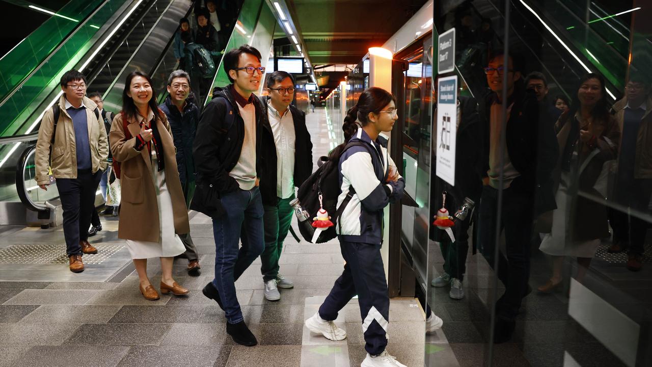 Pictured at Tallawong Station are MTR employees and commuters boarding one of the first Sydney Metro trains on its way back in to the city. The brand new Sydney Metro had its maiden run to Tallawong leaving Sydenham Station at 4.54am. Picture: Richard Dobson