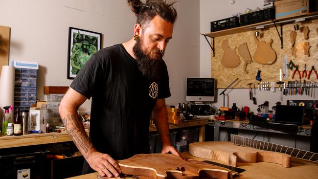 Jordan Reynolds can build a custom guitar from scratch, or repair your beloved instrument. Picture: Morgan Sette