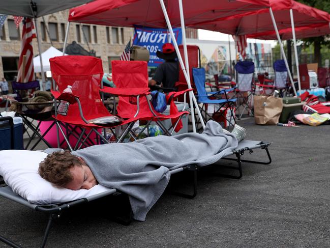 Supporters of US President Donald Trump sleep while lined up to attend the rally in Tulsa. Picture: AFP