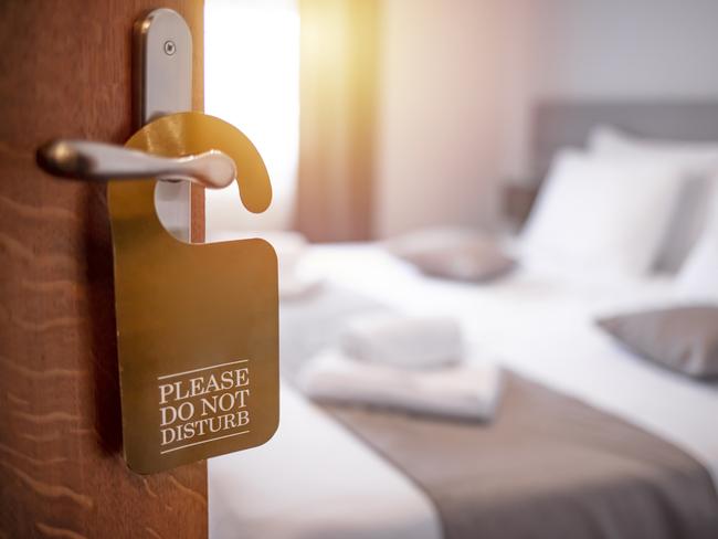 Hotel room door open. Clean and elegant accommodation service. Close up of handle. Travel, lodging and motel concept. Opened door of hotel room in morning with background blurred, copy space, sunlight effect.