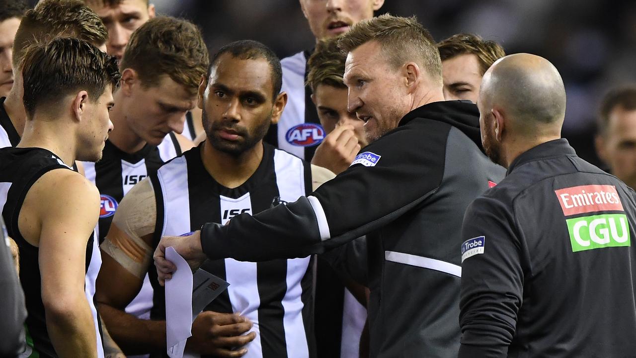 Magpies coach Nathan Buckley talks to his players at Marvel Stadium.