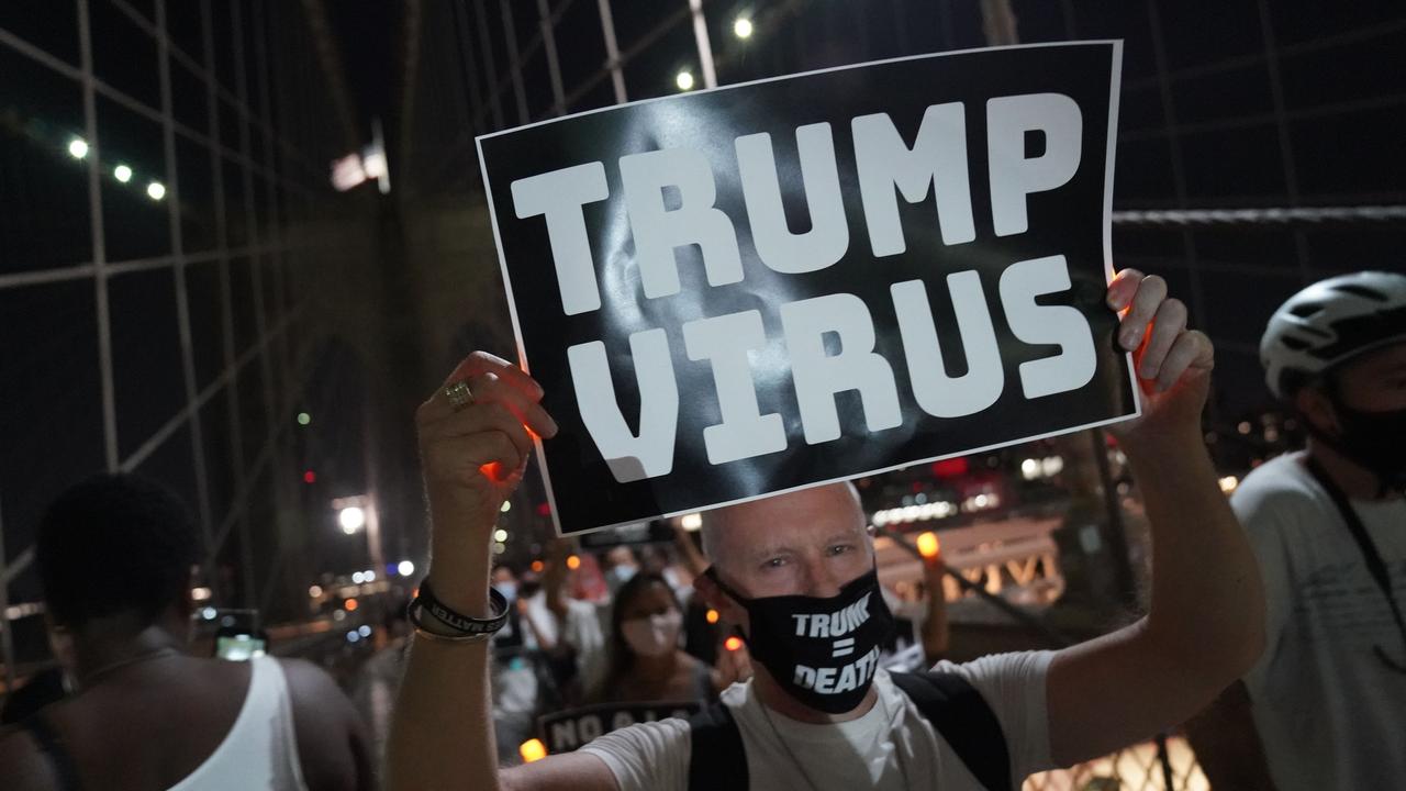 A man holds a placard during the "March for the Dead" across the Brooklyn Bridge, in memory of those who have died of COVID-19 and to protest the Trump administration's handling of the pandemic, on August 21, 2020 in New York. Picture: Bryan R. Smith/AFP