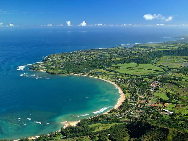 HANALEI BAY Kauai’s north shore beach, Hanalei Bay, shot to fame after George Clooney was filmed on its sandbanks for The Descendants movie. This crescent-shaped basin is constantly photographed for its surrounding white sands, sparkling waters and lush mountains. For an incredible view, especially at sunset, visit the cliffside Princeville Resort Kauai. Picture: Hawaii Tourism Authority / Ron Garnett