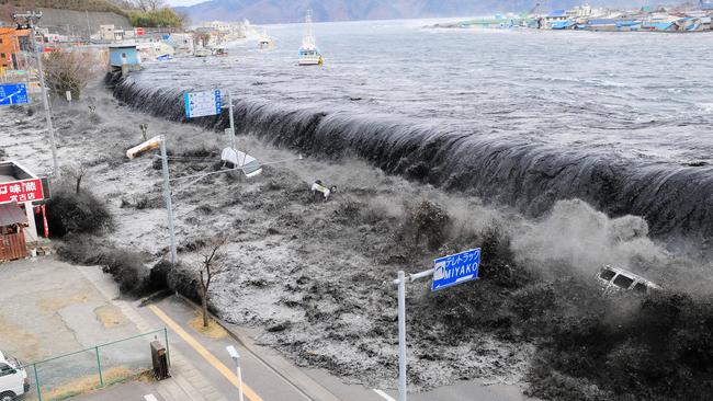 In this March 11, 2011 file photo, a tsunami floods over the breakwater protecting the coastal city of Miyako, Japan. Picture: File