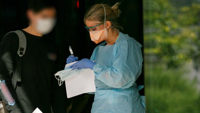 Patient in mask been seen by triage nurse at Northern Beaches Hospital's new COVID-19 clinic. Picture: Tim Pascoe