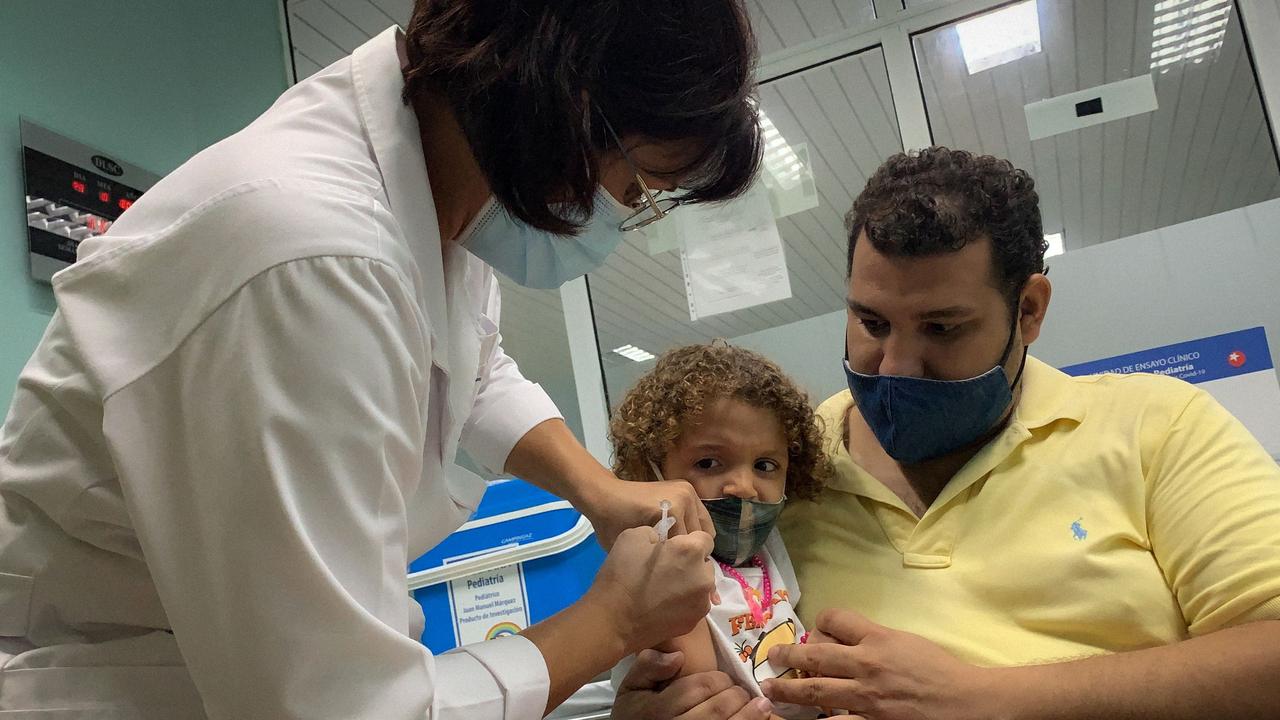 Pedro Montano holds his three-year-old daughter Roxana as she is vaccinated against Covid-19 in Havana, Cuba. Picture: Adalberto Roque/AFP