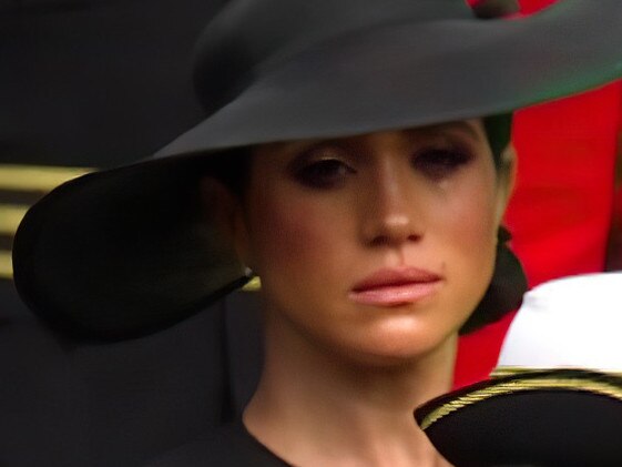 Meghan Markle's make-up appears to run as she sheds a tear during Queen Elizabeth's funeral.