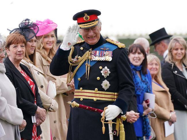 King Charles III smiles as he meets guests at Buckingham Palace. Picture: AFP