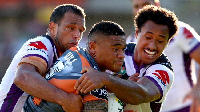 Tigers Moses Suli wrapped up by the defence during the round 4 NRL game between the Wests Tigers and the Melbourne Storm at Leichhardt Oval, Leichhardt. Picture: Gregg Porteous