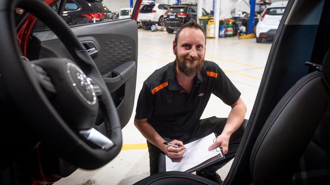 Darwin Services Group pre-delivery manager Brenton Thomas gives a new car a registration inspection. Picture: Che Chorley