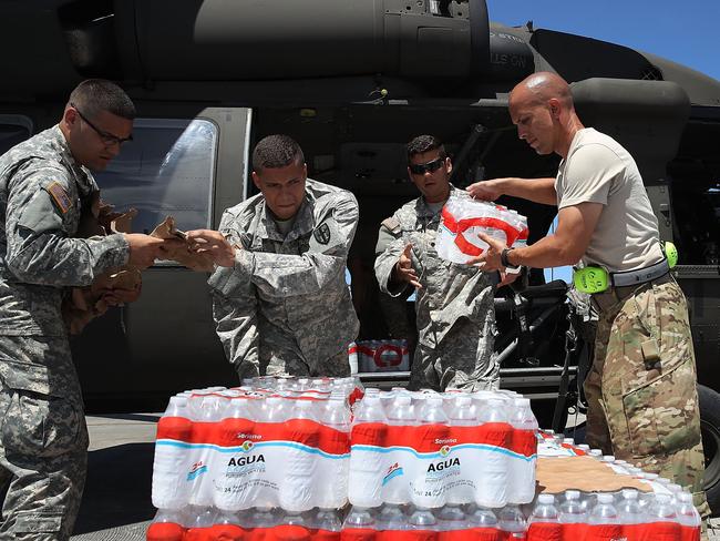 Puerto Rican National Guardsmen load a helicopter with food and water to bring to hurricane survivors as they deal with the aftermath of Hurricane Maria on September 29, 2017 in San Juan, Puerto Rico. Picture: Joe Raedle/Getty Images