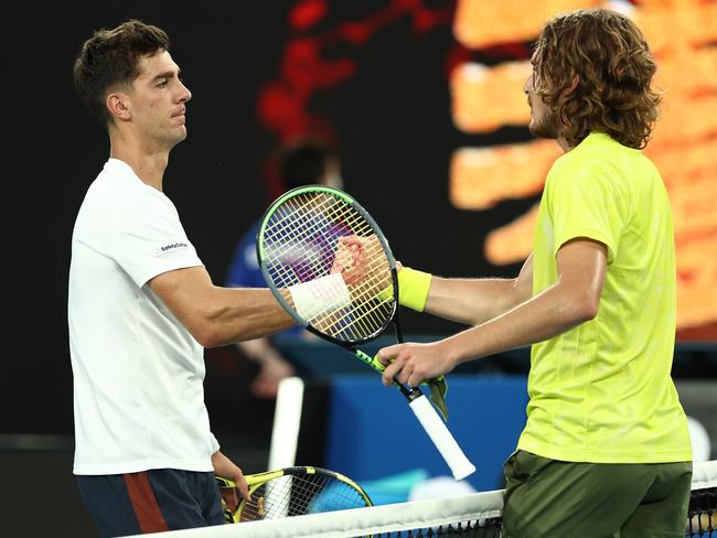 MELBOURNE, AUSTRALIA - FEBRUARY 11: Stefanos Tsitsipas of Greece and Thanasi Kokkinakis of Australia embrace at the net following their Men's Singles second round match during day four of the 2021 Australian Open at Melbourne Park on February 11, 2021 in Melbourne, Australia. (Photo by Cameron Spencer/Getty Images)