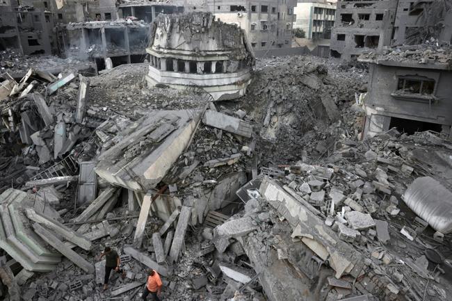 Palestinians inspect the destruction around Ahmed Yassin mosque, which was levelled by Israeli airstrikes, in Gaza City