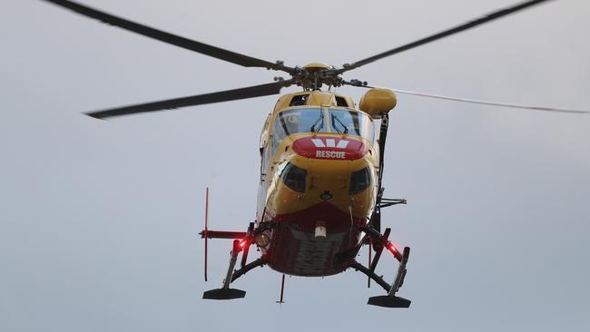 Missing Victorian bushwalker, Michael Bowman arrives via the Westpac Rescue helicopter with Tasmania Police at the Hobart Cenotaph. Picture: LUKE BOWDEN